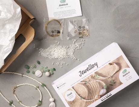 Jewelry DIY kits opened up and contents displayed on a table