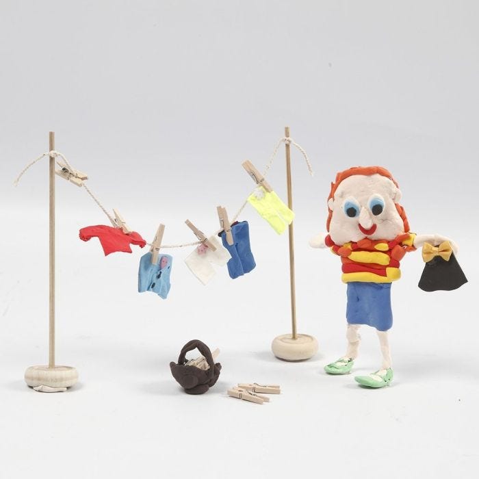 A Figure from Silk Clay and a wooden Clothes Horse with Clothes from Silk Clay with Clothes