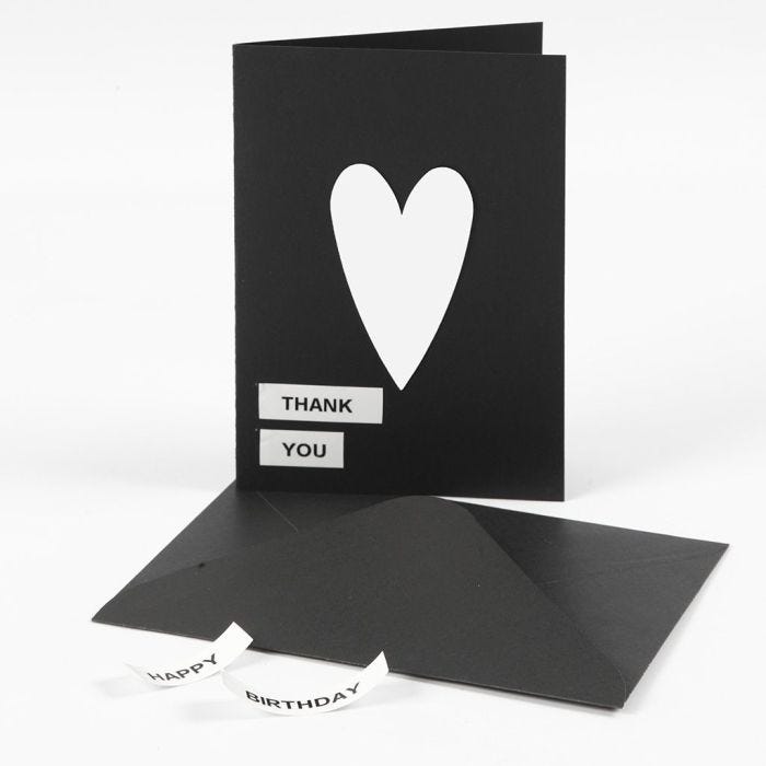 A Greeting Card with Text on DYMO Tape and a Card Heart