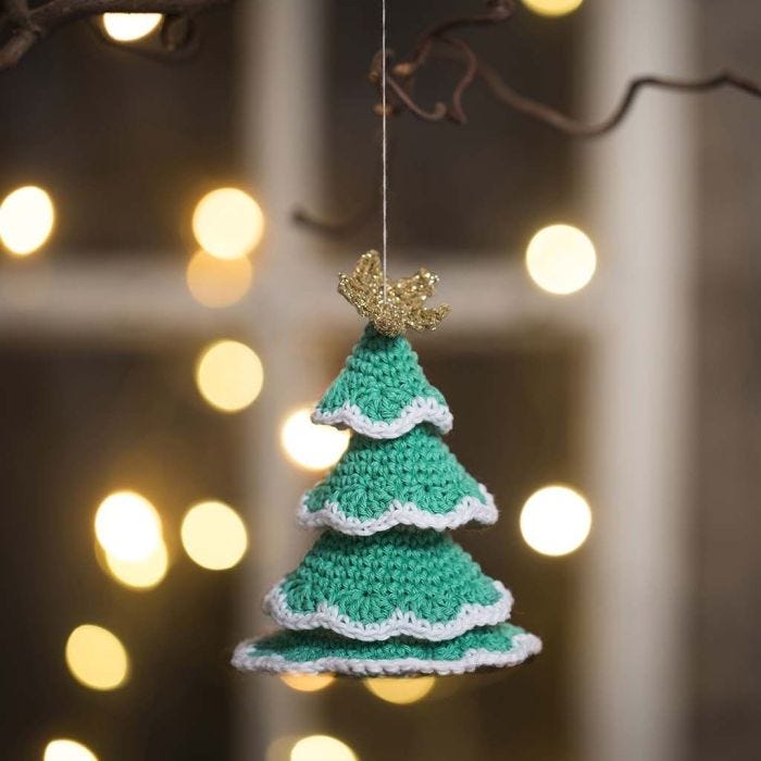 A Christmas tree crocheted from cotton yarn and gold yarn