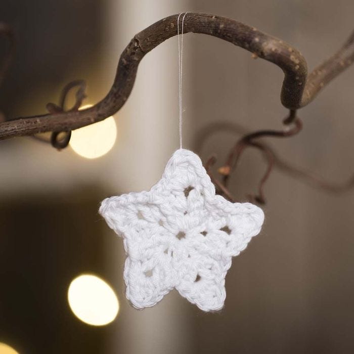 A small star crocheted from cotton yarn