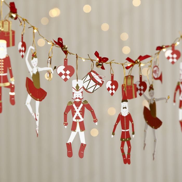 A Garland from LED Lights with Nutcracker Jumping Jacks and Bells