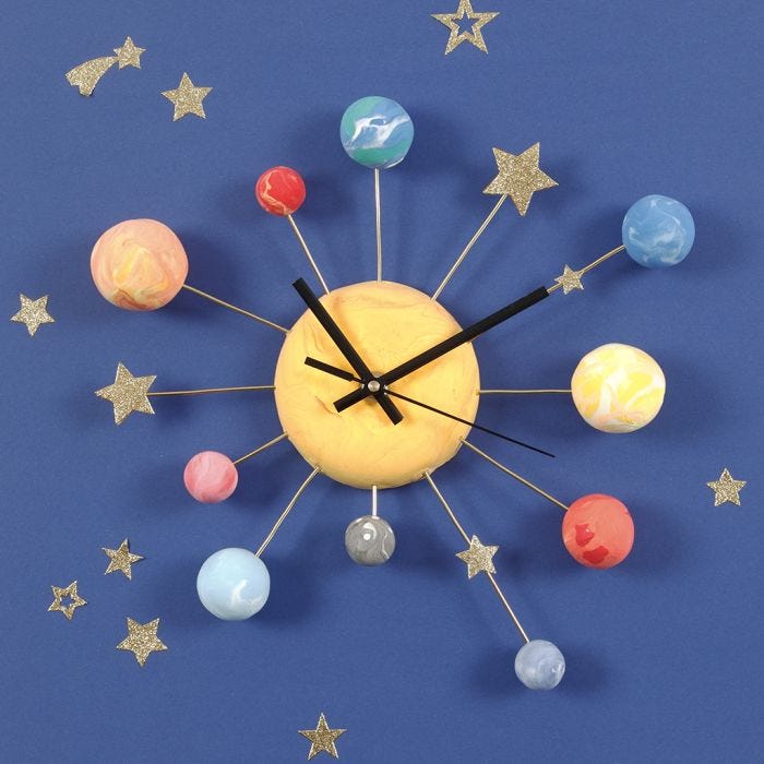 A Wall Clock decorated with Silk Clay Planets, Star Stickers and Bonsai Wire