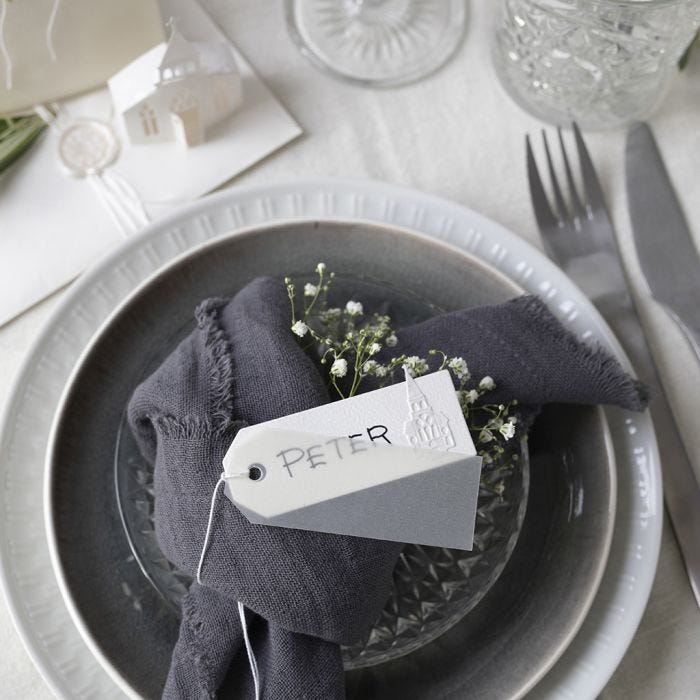 Place cards in off-white shades with a punched-out church and vellum paper