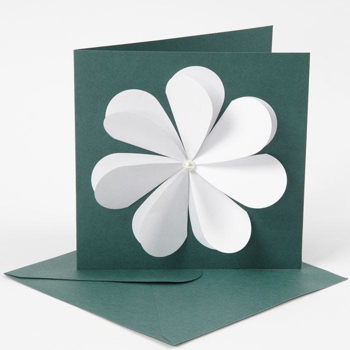 A greeting card with a flower made from punched-out hearts