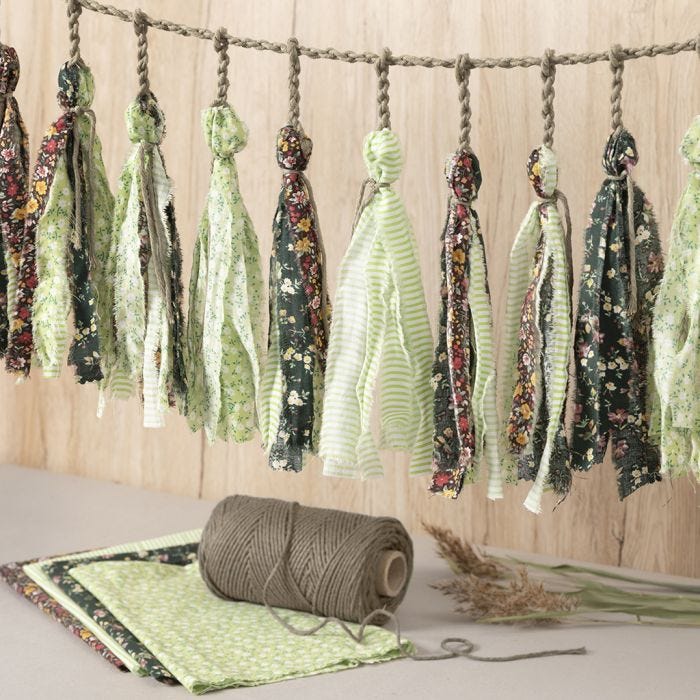 A macramé cord garland with fabric tassels