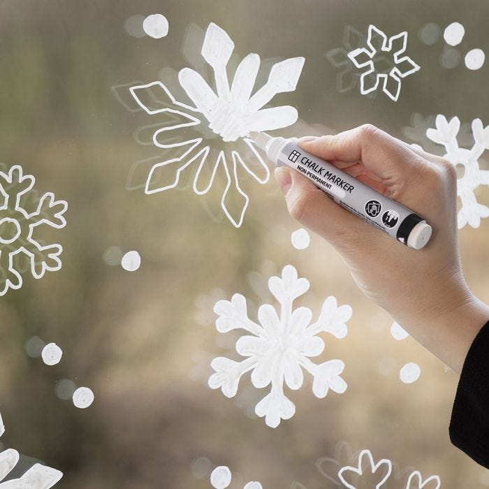 Snowflake window decoration with chalk markers