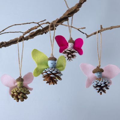 Enchanting pine cone fairies with acorn caps