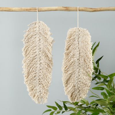 A macramé hanging decoration shaped like a leaf