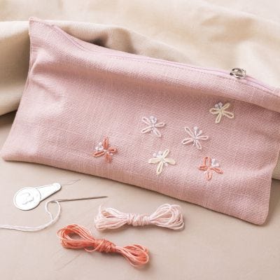 Faux leather clutch bag with embroidered butterflies