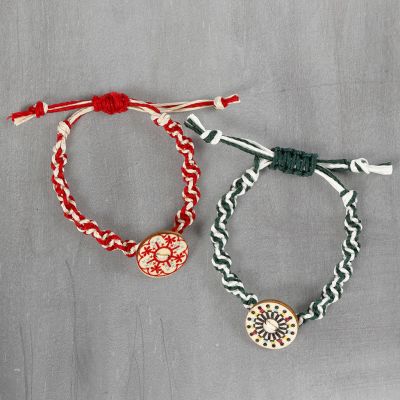 A braided bracelet made from bamboo cord with a wooden button